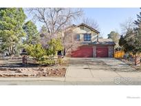 Charming two-story home features a brick facade, mature trees, and a spacious two-car garage with red doors at 8239 Kincross Way, Boulder, CO 80301