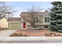 Charming home featuring a red front door, stone accents, and a well-maintained front yard at 138 S Washington Ave, Louisville, CO 80027