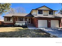 Charming two-story home with brick accents, manicured landscaping, and a two-car garage at 2136 Westlake Dr, Longmont, CO 80503