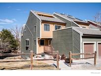 Townhouse exterior with a light wood fence, light-colored gravel, and multiple earth-toned sidings at 2885 Springdale Ln, Boulder, CO 80303