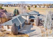 Stunning home showcasing mature landscaping and a large driveway with a spacious three-car garage at 4405 Fairway Ln, Broomfield, CO 80023