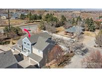 A bird's eye view of this inviting blue, multi-level home and neighborhood, with mature trees and charming curb appeal at 588 Beauprez Ave, Lafayette, CO 80026