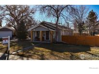 Charming home featuring a well-maintained front yard with a cozy porch and modern front door at 6240 W 24Th Ave, Edgewater, CO 80214