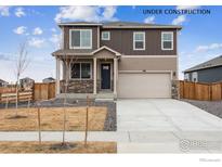 Under construction, a two story home showcasing varied textures, a spacious driveway and landscaping is yet to be completed at 6537 13Th St, Frederick, CO 80530