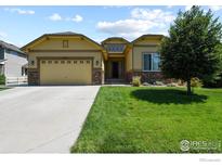 Inviting single Gathering home featuring a two car garage and manicured lawn, great curb appeal at 9150 Ferncrest St, Firestone, CO 80504