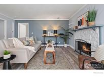 Cozy living room with a stone fireplace, modern furniture, and stylish decor at 12450 E Cornell Ave # 304, Aurora, CO 80014