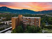 Stunning exterior view of building complex with views of the mountain range and colorful sunset sky in the background at 1850 Folsom St # 1012, Boulder, CO 80302