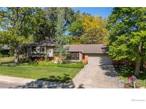 Charming home with a well-manicured lawn, mature trees, and inviting curb appeal at 255 Kiowa Pl, Boulder, CO 80303