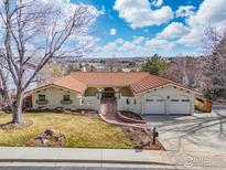 Stunning stucco home with red tile roof, gated courtyard entry, and a three car garage at 2895 Iliff St, Boulder, CO 80305
