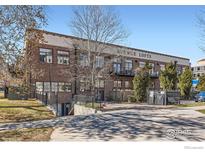 Brick building exterior featuring multiple windows and balconies with Avenue Lofts signage at the top at 1000 E 18Th Ave, Denver, CO 80218