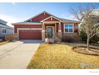 Charming single-Gathering home with a manicured lawn and brick accents at 1038 Petras St, Erie, CO 80516
