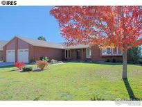 Charming single-story home features a well-manicured lawn and mature landscaping at 1143 Purdue Dr, Longmont, CO 80503