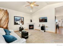 Inviting living room features a cozy fireplace, stylish decor, and comfortable seating at 175 Redcloud Ave, Berthoud, CO 80513