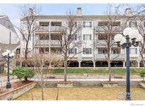 Three-story condo building features private balconies and manicured lawns at 2201 Pearl St # 110, Boulder, CO 80302
