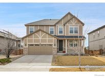 Charming two-story home with a two-car garage, neutral colors, and landscaped front yard at 316 Taurus Dr, Erie, CO 80516