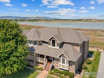 Beautiful exterior showcasing a multi-story home with water views and manicured landscaping at 3916 Fowler Ln, Longmont, CO 80503