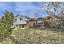 Charming home features a brick facade, light-green siding, and mature trees, creating a welcoming curb appeal at 4288 Graham Ct, Boulder, CO 80305