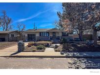 Charming single-story home boasts a glass garage door and inviting front yard landscaping at 4360 Ludlow St, Boulder, CO 80305