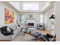 Airy living room features a fireplace, modern decor, lots of natural light, and beautiful architectural details at 4860 Fountain St, Boulder, CO 80304