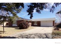 Charming brick home with solar panels and a well-maintained front yard at 680 Kalmia Way, Broomfield, CO 80020