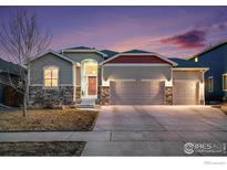 Charming exterior of a two-story home featuring a three-car garage and well-maintained landscaping at 6820 Indian Paintbrush St, Frederick, CO 80530