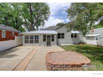 Charming single Gathering home featuring a sunroom, landscaped yard, and mature trees at 724 Carbon St, Erie, CO 80516