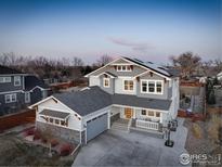 Stunning two-story home showcasing professionally landscaped yard with solar panels and bench at 785 Delechant Dr, Erie, CO 80516