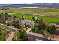 Stunning aerial view of home with a beautifully landscaped yard and mountain views at 8845 Crimson Clover Ln, Longmont, CO 80503