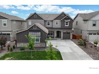 Charming two-story home boasts meticulous landscaping, and a welcoming facade with stone accents and a cozy front porch at 890 Meadowlark Dr, Erie, CO 80516