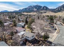 Stunning aerial view of a neighborhood with a mountain backdrop on a sunny day at 1120 Green Cir, Boulder, CO 80305