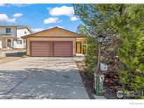 Charming single-story home features a two-car garage and well-manicured landscaping at 140 Judson St, Longmont, CO 80501