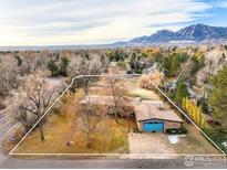 Charming home with a blue garage door and a spacious lot, nestled beneath a scenic mountain range at 2550 Linden Ave, Boulder, CO 80304