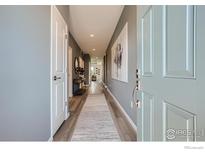 Inviting hallway features sleek flooring, modern decor, and neutral color palette at 2723 Crystal Springs, Longmont, CO 80503