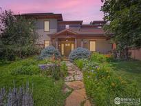 Charming two-story home featuring a beautifully landscaped front yard with a stone pathway at 3135 11Th St, Boulder, CO 80304