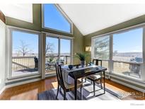 Bright dining area with large windows offering scenic views and access to the outdoor deck at 3885 Telluride Pl, Boulder, CO 80305