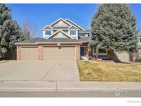 Charming two-story home with a brick facade, three-car garage, and well-maintained lawn at 520 Campo Way, Superior, CO 80027