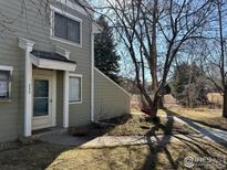 Charming two-story exterior with a welcoming front entrance, mature trees, and a well-maintained lawn at 8044 Countryside Park # 220, Longmont, CO 80503