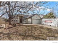 Charming single-story home with well-maintained lawn and mature trees at 1148 Chestnut Dr, Longmont, CO 80503