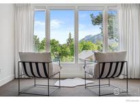 Bright living room featuring neutral decor, mountain views, and plenty of natural light at 1221 Linden Ave, Boulder, CO 80304