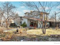 Charming two-story home with covered porch and mature trees in a lush landscape at 130 S 36Th St, Boulder, CO 80305