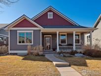 Charming two-story home with a welcoming front porch and well-maintained landscaping at 1451 Moonlight Dr, Longmont, CO 80504