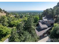 Beautiful home with lush surrounding landscape and neighborhood views, featuring a porte-cochere entryway at 15 Arrowleaf Ct, Boulder, CO 80304