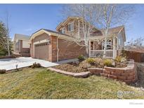 Charming two-story home with brick accents, covered porch, and well-maintained landscaping at 2236 Alpine Dr, Erie, CO 80516