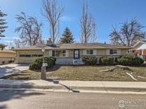 Charming ranch-style home with a well-maintained front yard and a cozy picket fence at 2907 University Ave, Longmont, CO 80503