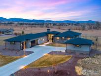 Stunning exterior showcasing modern architecture with professional landscaping and mountain views at 3210 Mallard Creek Rd, Berthoud, CO 80513