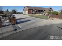 Beautiful exterior of a brick home featuring a well-maintained lawn and a spacious driveway at 3310 Routt St, Wheat Ridge, CO 80033