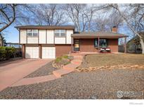 Charming two-story home with brick and siding exterior, a two car garage, and inviting front porch at 4631 Ashfield Dr, Boulder, CO 80301