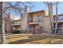 Charming townhouse featuring a private balcony, fenced yard, and well-maintained landscaping at 5052 Buckingham Rd, Boulder, CO 80301