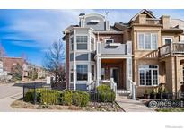 Charming townhome with a mix of brick and siding, featuring a covered porch and landscaped front yard at 555 Laramie Blvd, Boulder, CO 80304