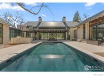 Stunning backyard pool and patio area with modern architectural details and unobstructed view at 775 Kalmia Ave, Boulder, CO 80304